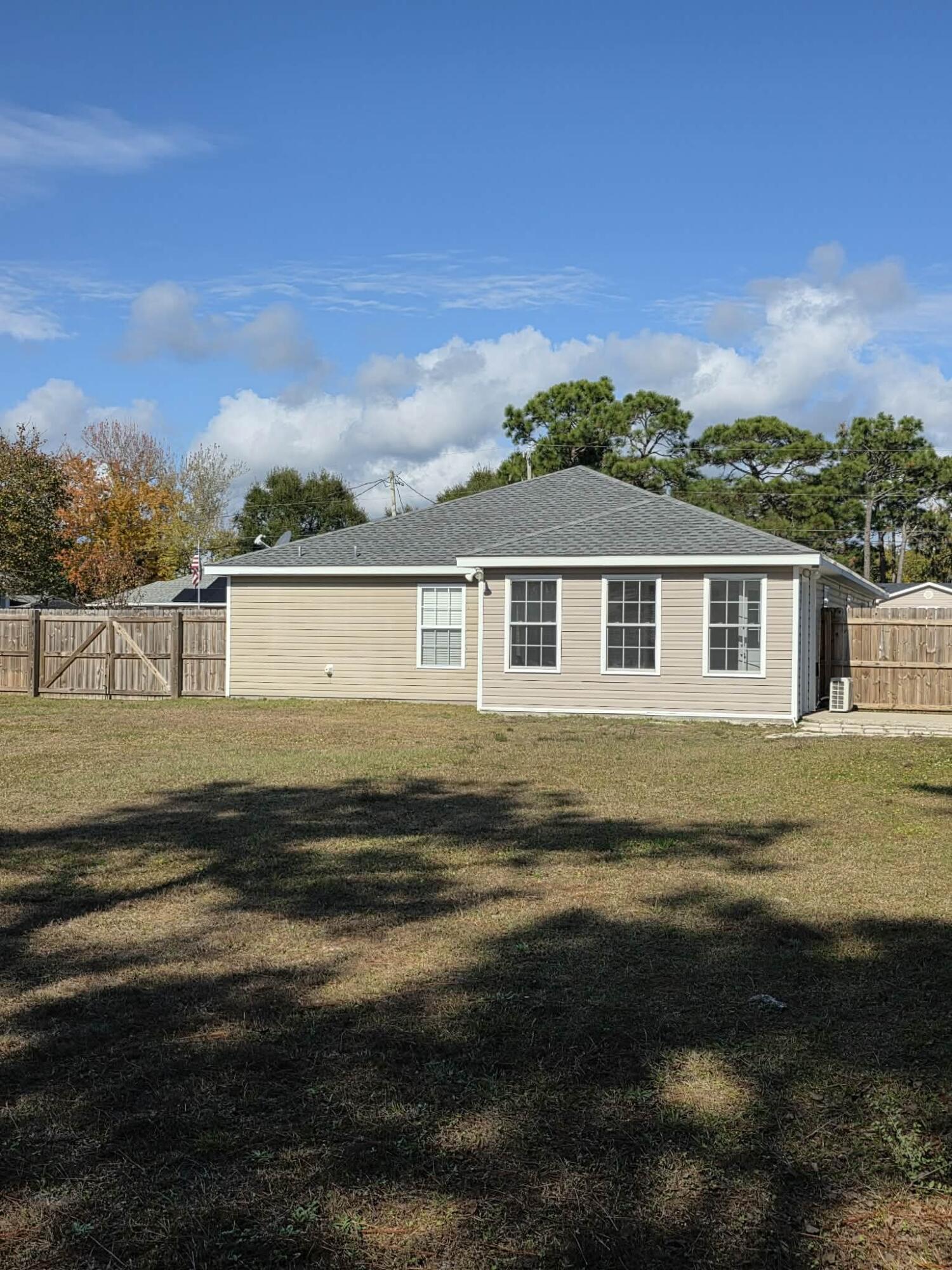 8347 Tavira Street Navarre, FL 32566 - Photo 43 of 49 a view of a house with a yard