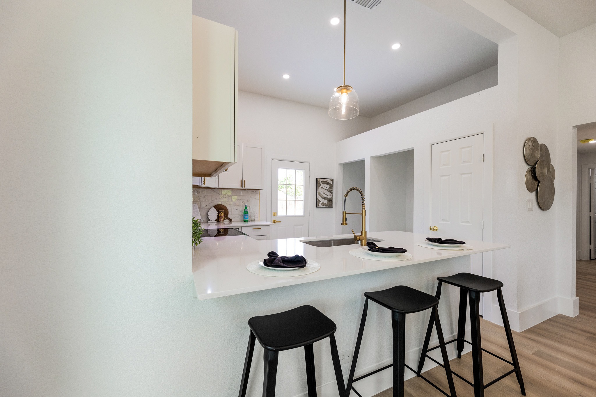 910 West 4th Street Taylor, TX 76574 - Photo 11 of 38 a kitchen with stainless steel appliances a table and chairs in it