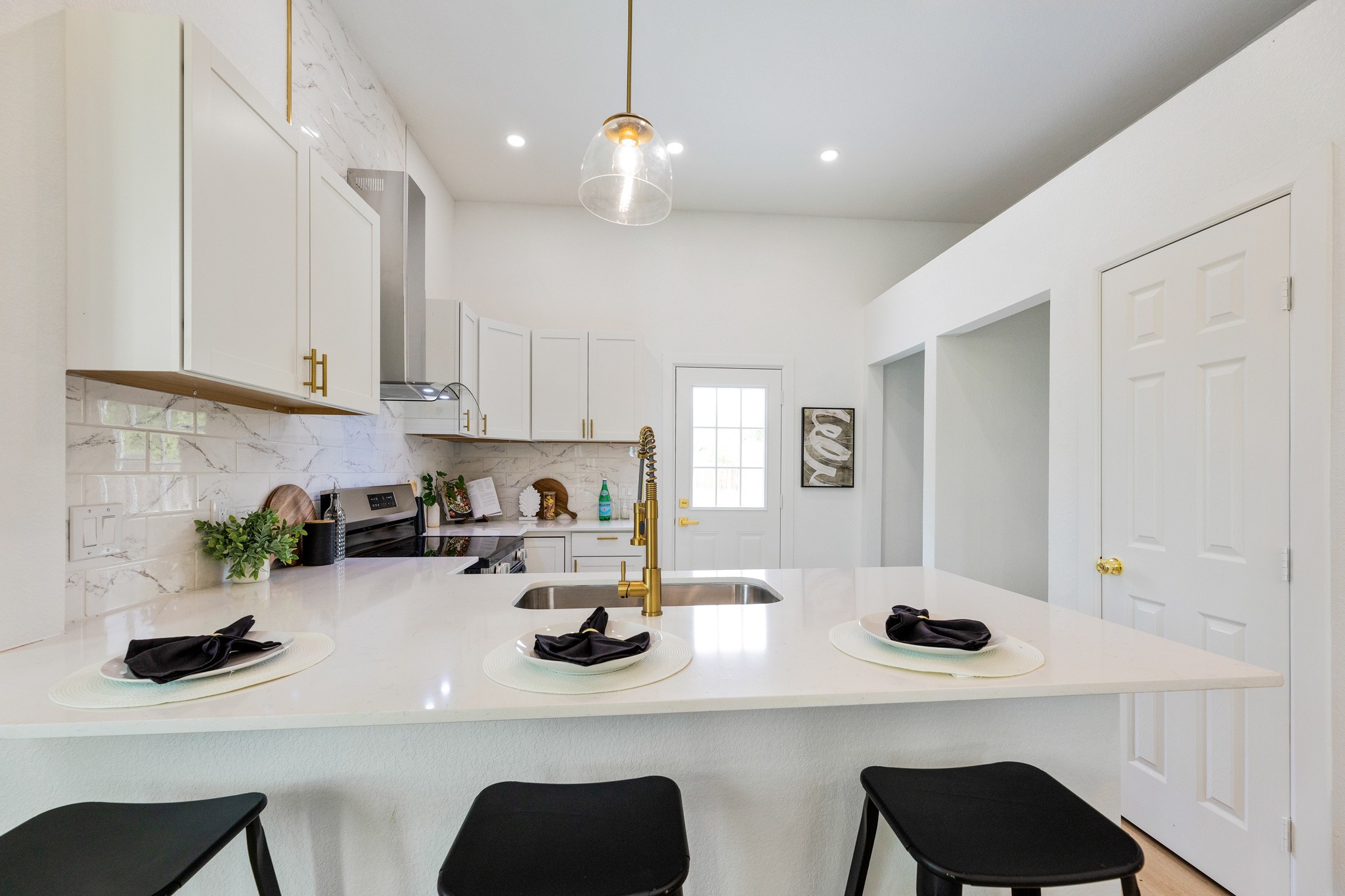 910 West 4th Street Taylor, TX 76574 - Photo 12 of 38 a kitchen with a sink and cabinets