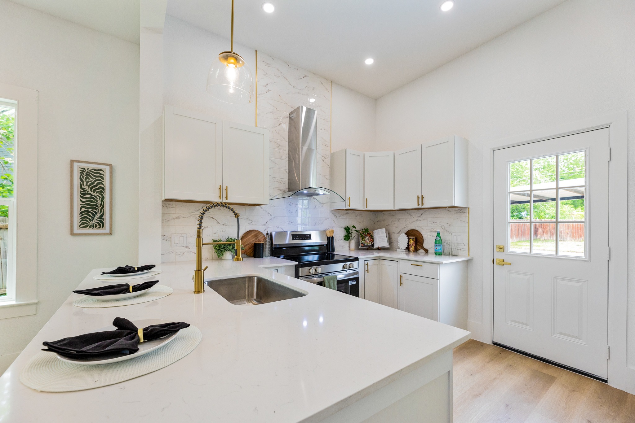 910 West 4th Street Taylor, TX 76574 - Photo 13 of 38 a kitchen with sink a stove and cabinets
