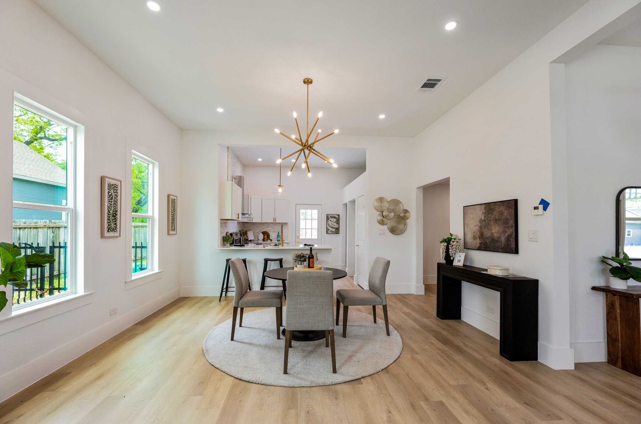 910 West 4th Street Taylor, TX 76574 - Photo 18 of 38 a view of a dining room with furniture a kitchen wooden floor and chandelier