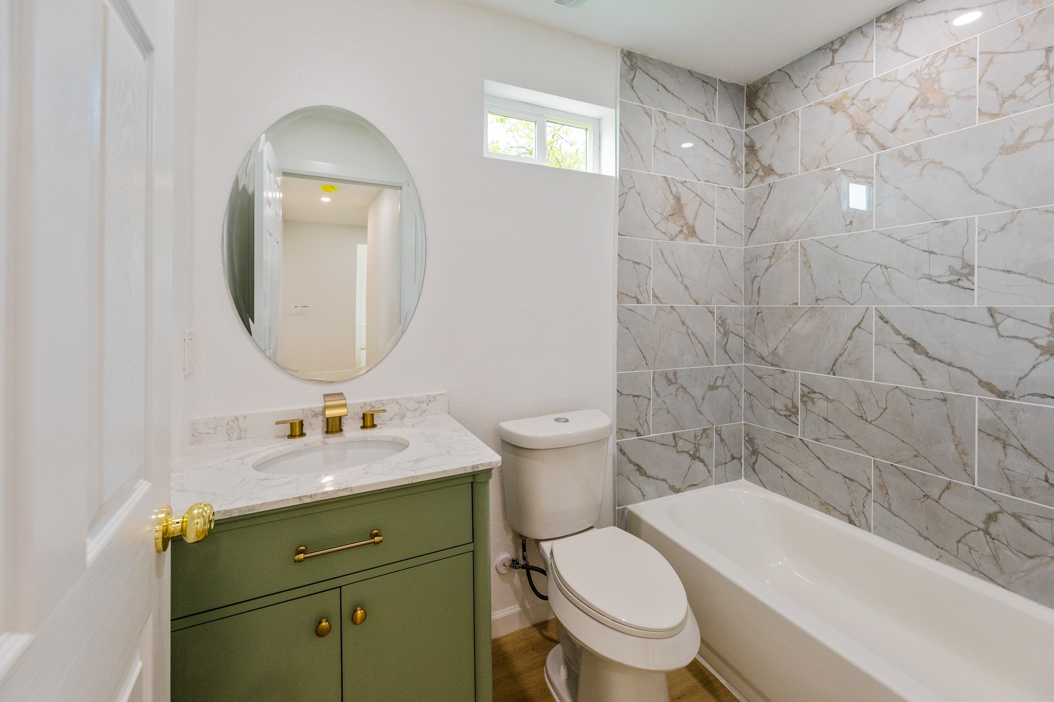 910 West 4th Street Taylor, TX 76574 - Photo 30 of 38 a bathroom with a granite countertop toilet a sink and a mirror