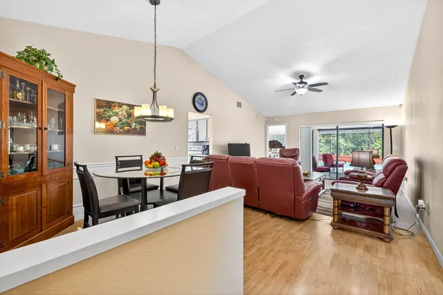a living room with furniture ceiling fan and a rug
