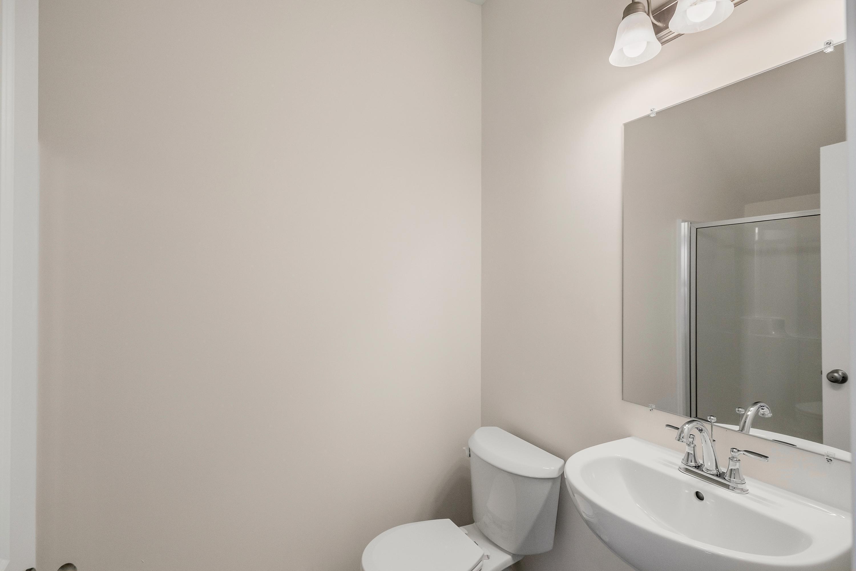 6169 Rushing Avenue Portage, IN 46368 - Photo 13 of 14 a bathroom with a sink mirror and toilet