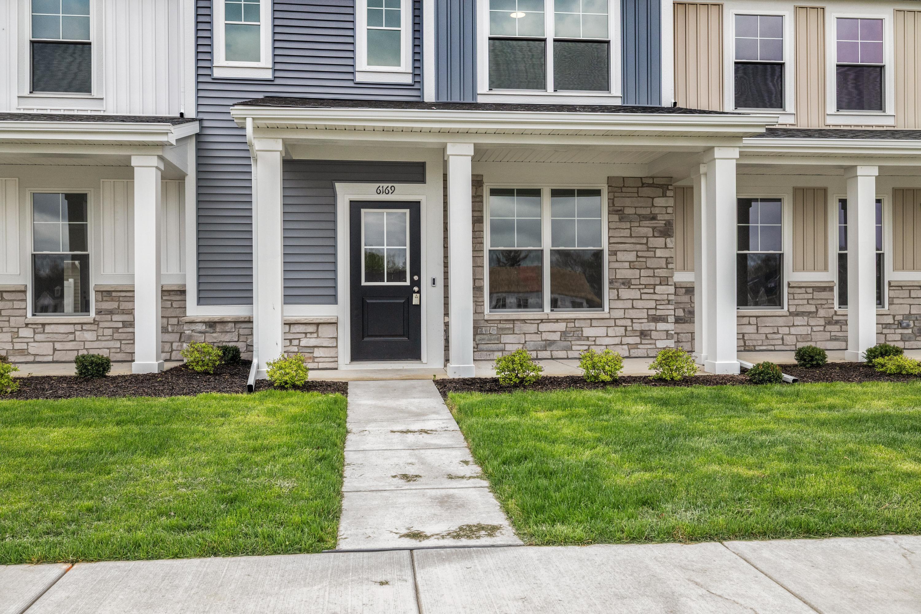 6169 Rushing Avenue Portage, IN 46368 - Photo 2 of 14 a front view of a house with garden