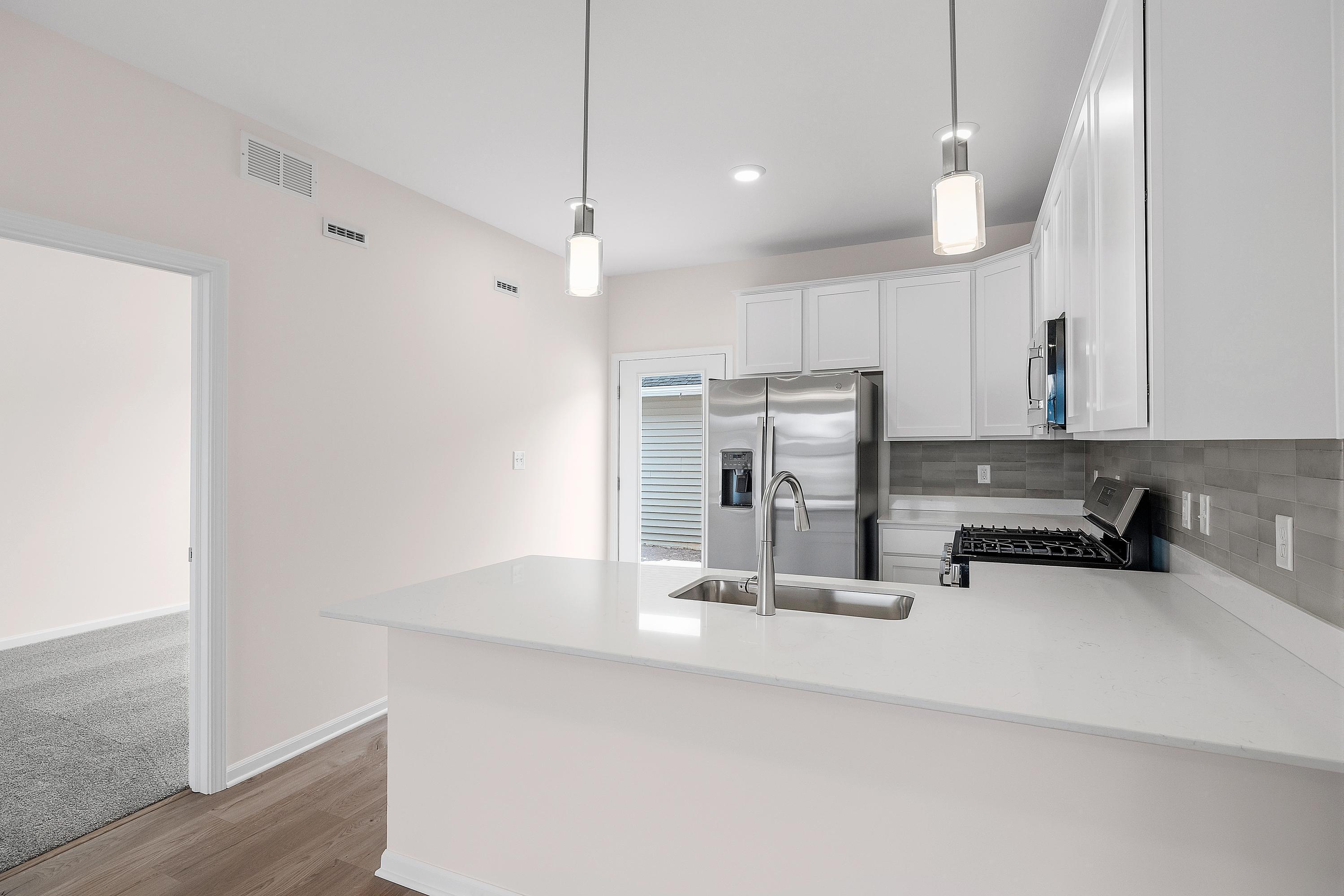 6169 Rushing Avenue Portage, IN 46368 - Photo 5 of 14 a kitchen with stainless steel appliances a sink and a refrigerator
