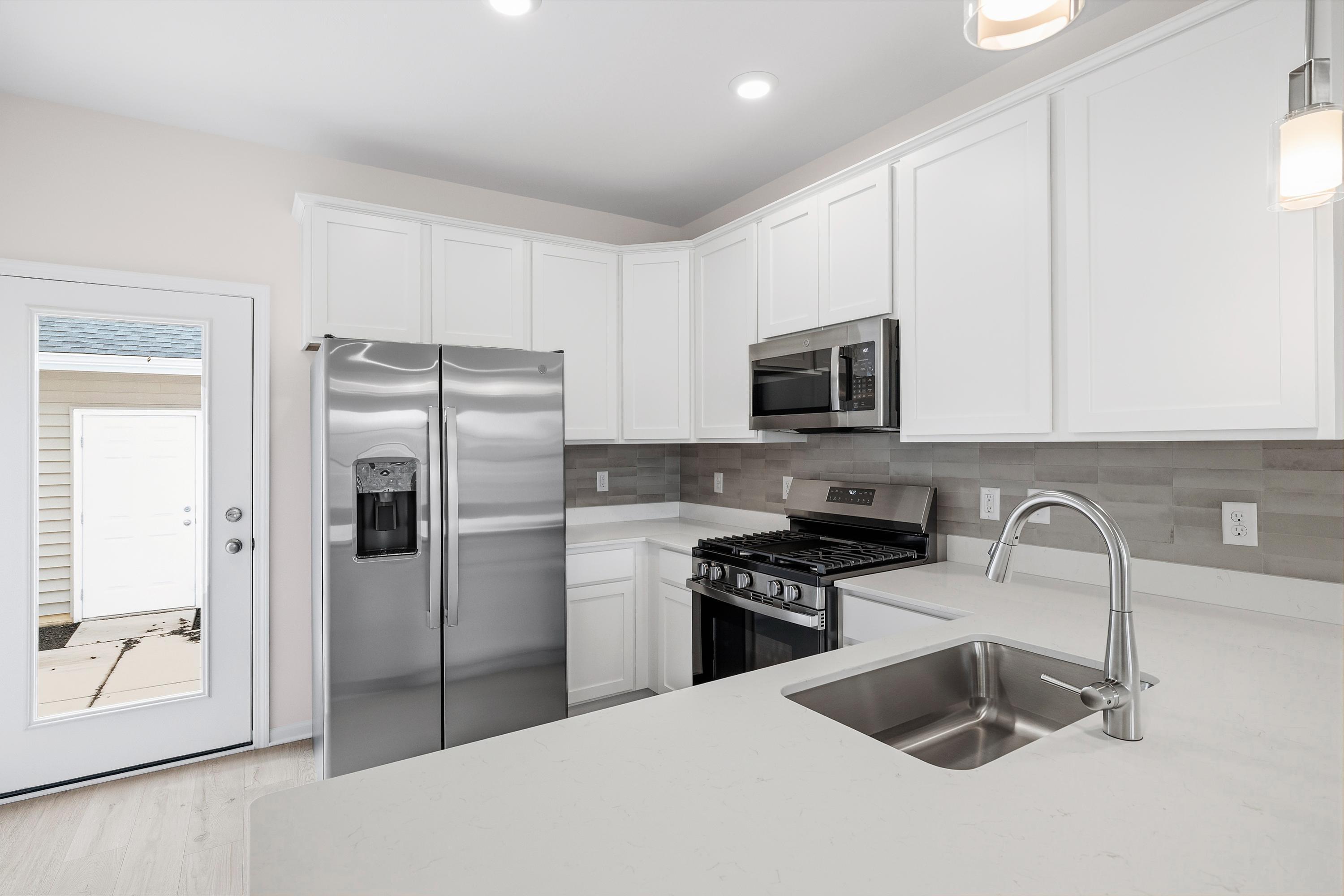 6169 Rushing Avenue Portage, IN 46368 - Photo 6 of 14 a kitchen with stainless steel appliances granite countertop a refrigerator stove and sink