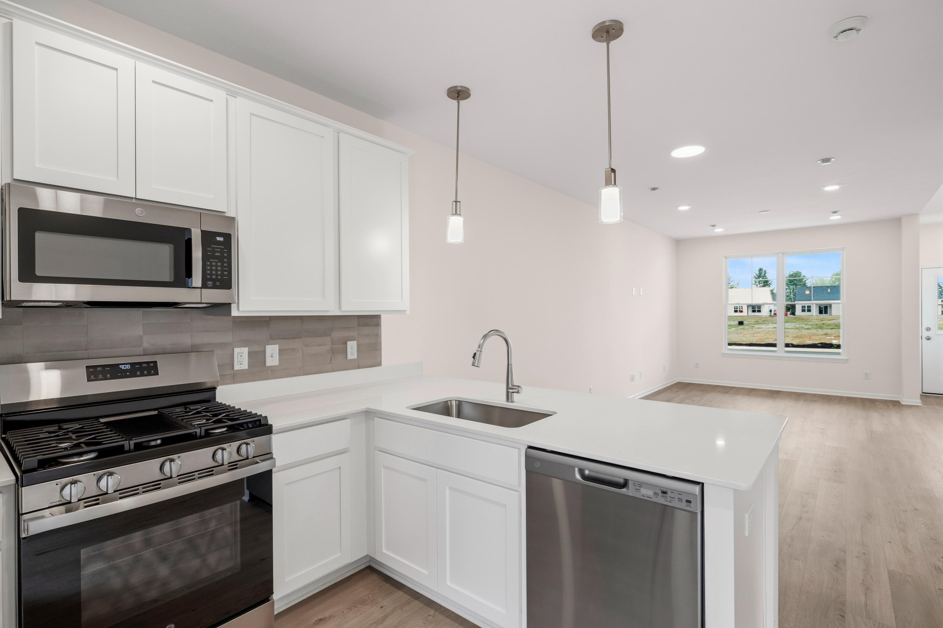 6169 Rushing Avenue Portage, IN 46368 - Photo 7 of 14 a kitchen with stainless steel appliances white cabinets and a stove top oven