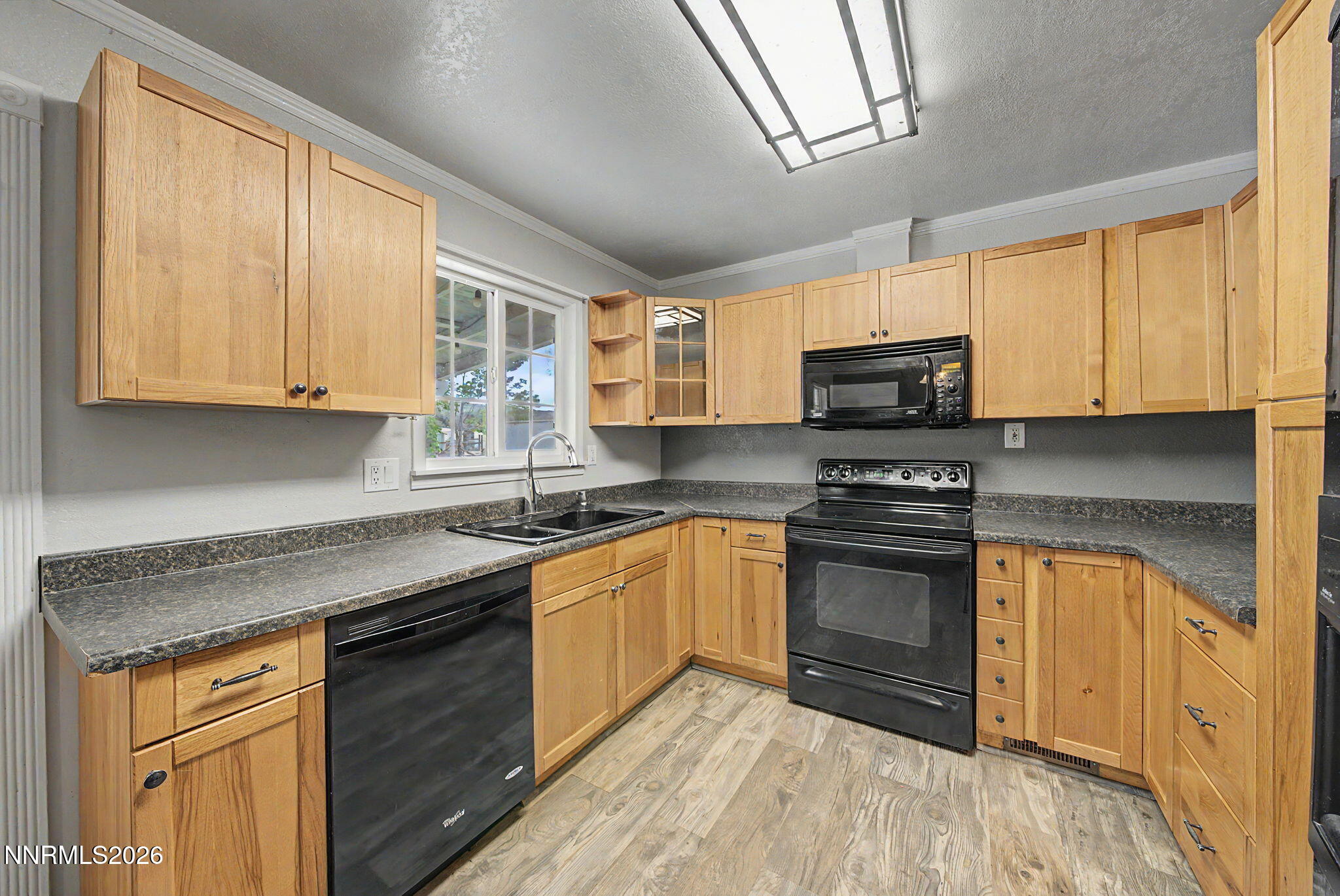 11577 Deodar Way Reno, NV 89506 - Photo 16 of 58 a kitchen with stainless steel appliances granite countertop a stove sink microwave and window