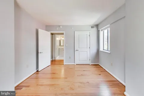 a view of an empty room with wooden floor