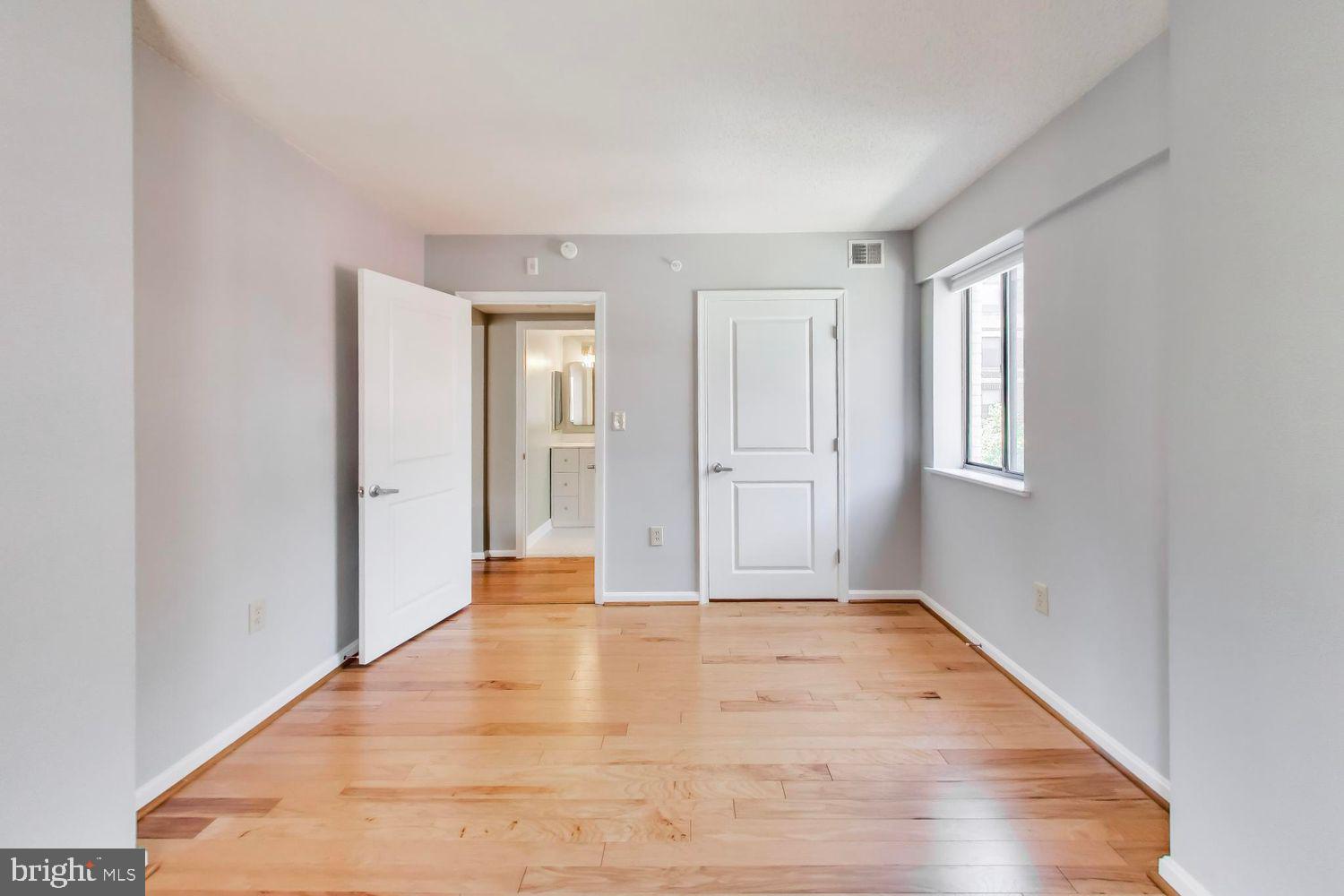 1225 13th Street Northwest, Unit 506 Washington, DC 20005 - Photo 13 of 18 a view of an empty room with wooden floor