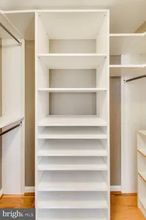 a view of walk in closet with empty racks