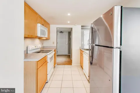 a kitchen with a refrigerator and a sink