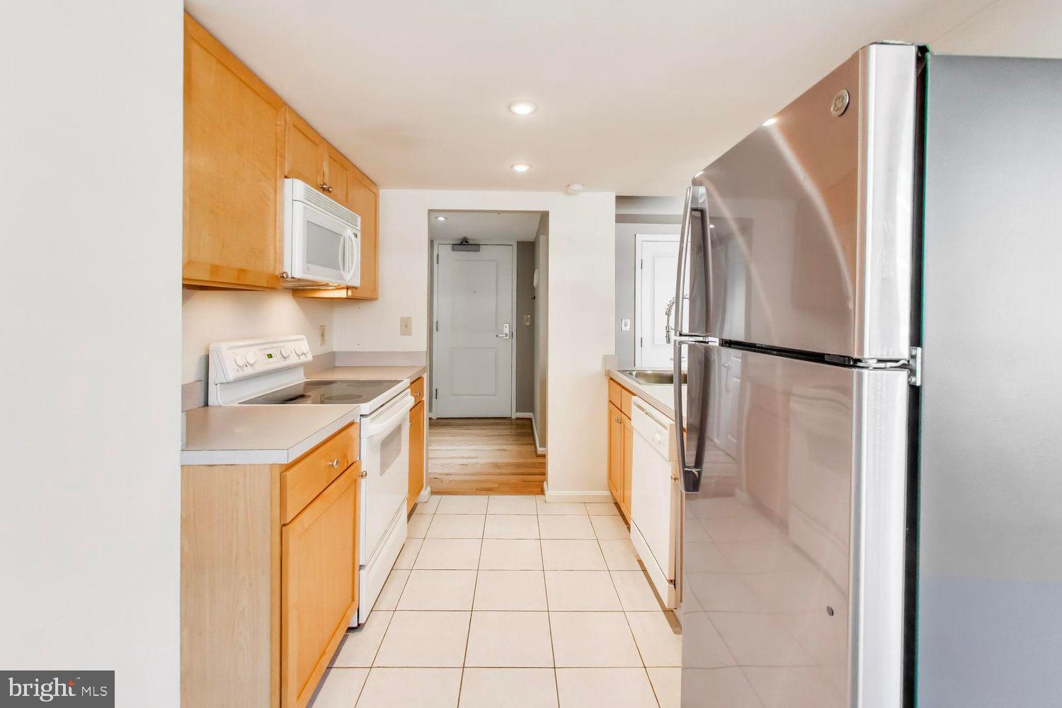 1225 13th Street Northwest, Unit 506 Washington, DC 20005 - Photo 8 of 18 a kitchen with a refrigerator and a sink