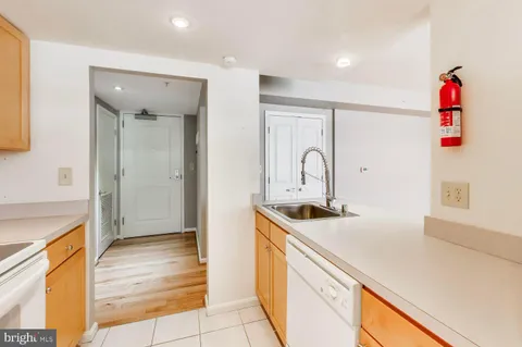 a kitchen with a sink and a refrigerator