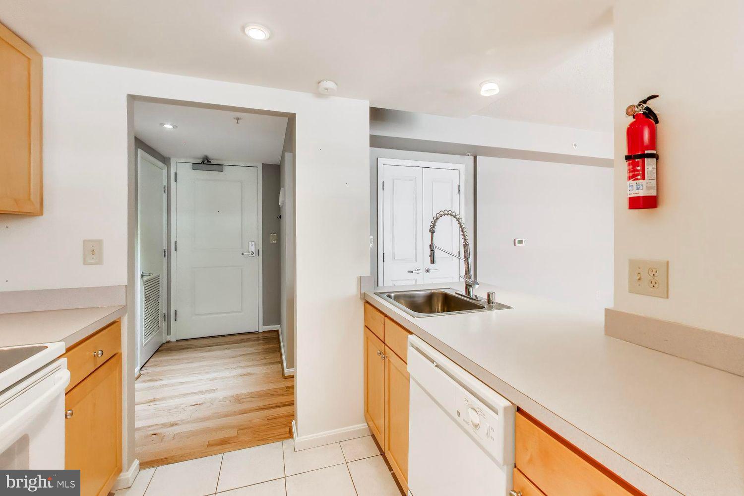 1225 13th Street Northwest, Unit 506 Washington, DC 20005 - Photo 9 of 18 a kitchen with a sink and a refrigerator