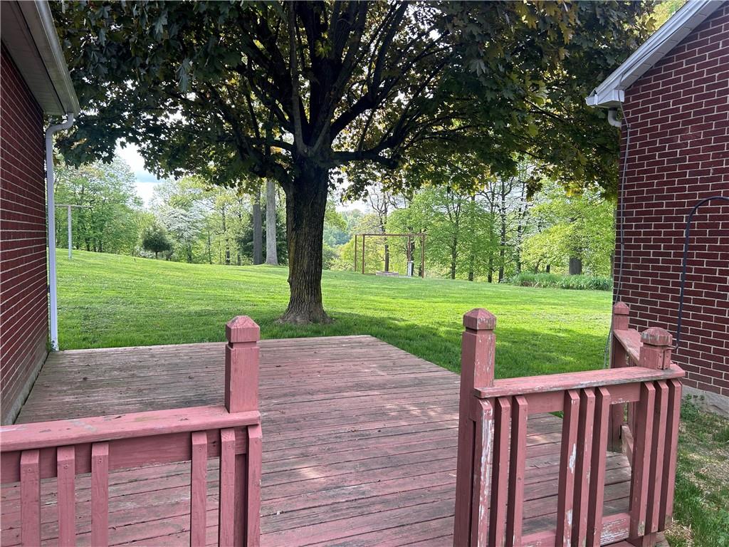 1023 Bonniebrook Road Butler, PA 16002 - Photo 21 of 40 a view of a deck with a table and chairs under a large tree