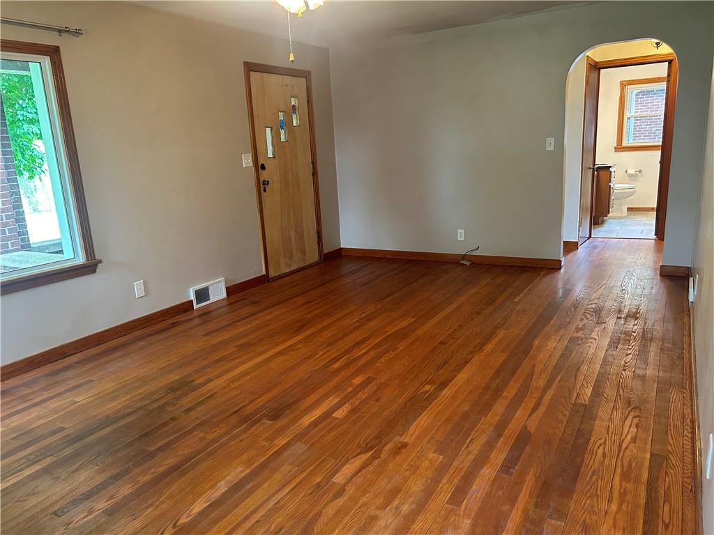 1023 Bonniebrook Road Butler, PA 16002 - Photo 3 of 40 a view of an empty room with wooden floor and a window