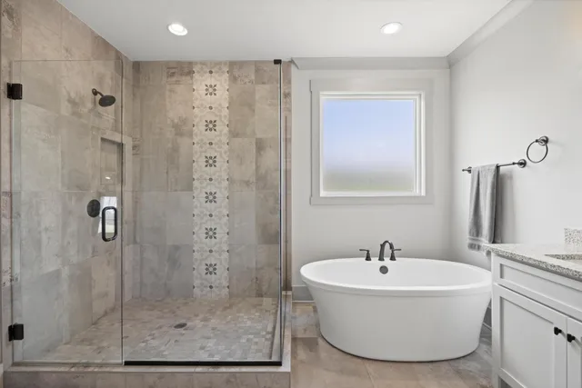 a white bath tub sitting next to a bathroom