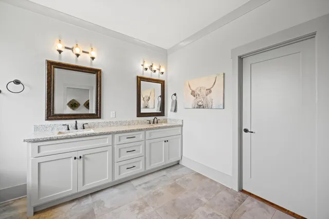 a bathroom with a double vanity sink and a mirror