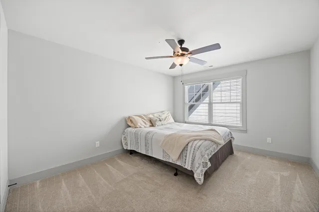 a spacious bedroom with a bed and a window