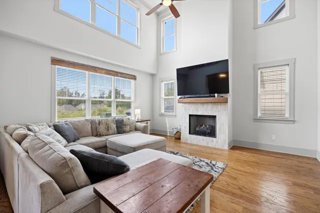 a living room with furniture a flat screen tv and a fireplace