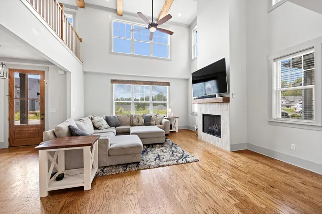 a living room with fireplace furniture and a flat screen tv