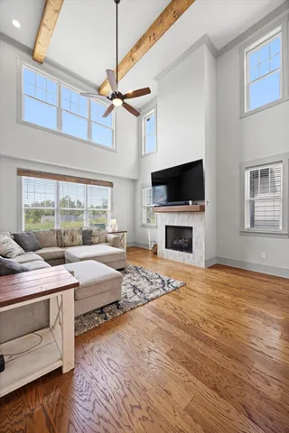 a room with a bed a flat screen tv and a fireplace