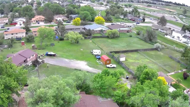 an aerial view of residential houses with outdoor space and swimming pool