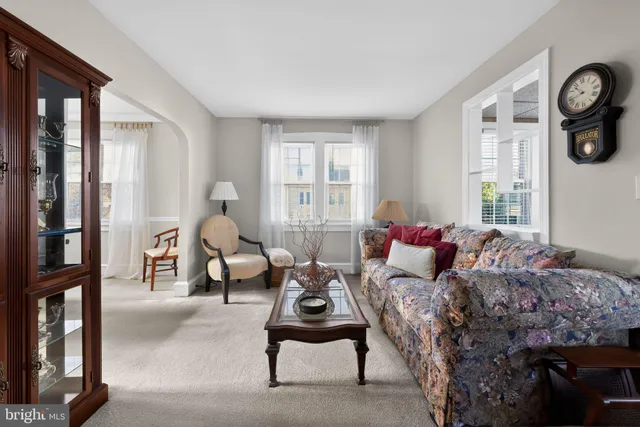 a kitchen with a dining table chairs and white cabinets
