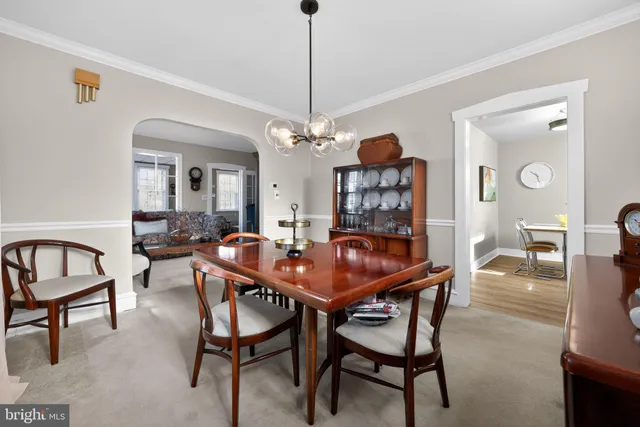 a view of a dining room with furniture and a chandelier