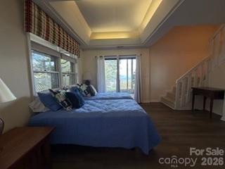 19 Lookout Loop Burnsville, NC 28714 - Photo 26 of 30 a bed room with a bed window and a potted plant