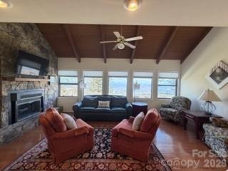19 Lookout Loop Burnsville, NC 28714 - Photo 10 of 30 a living room with furniture a fireplace and a large window