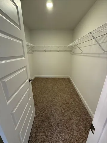 a spacious bathroom with a tub and a double vanity sink