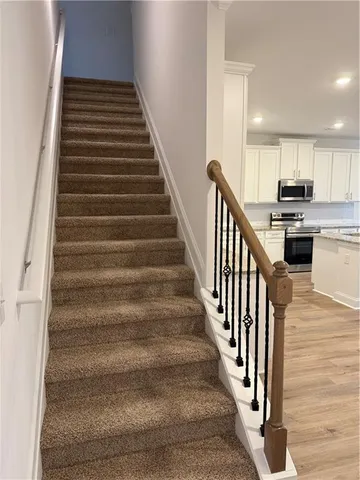a view of entryway and hall with wooden floor