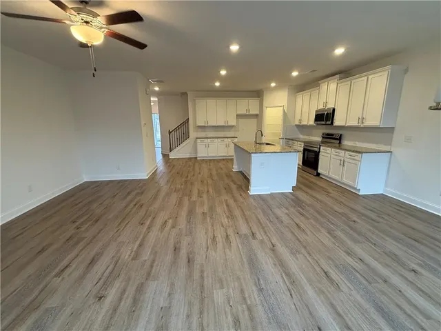 a view of kitchen with kitchen island microwave and stove