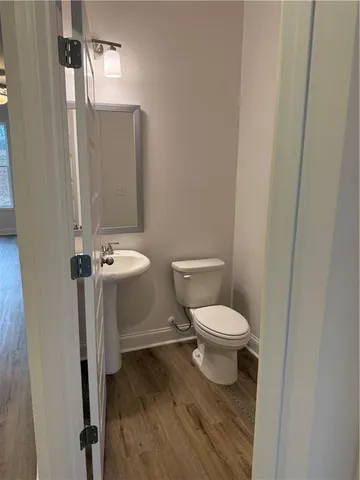 a white toilet sitting next to a bathroom sink