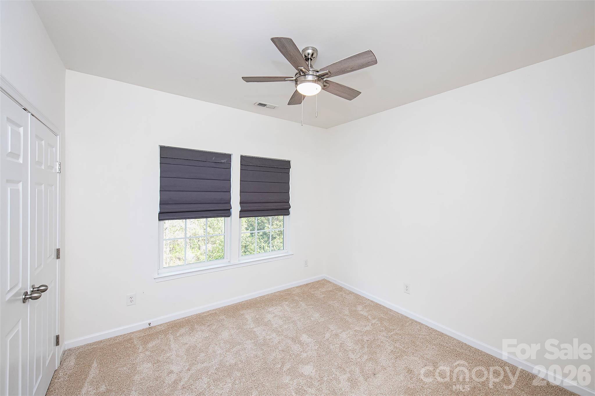 1957 Faison Avenue Fort Mill, SC 29708 - Photo 19 of 33 an empty room with a window and a ceiling fan