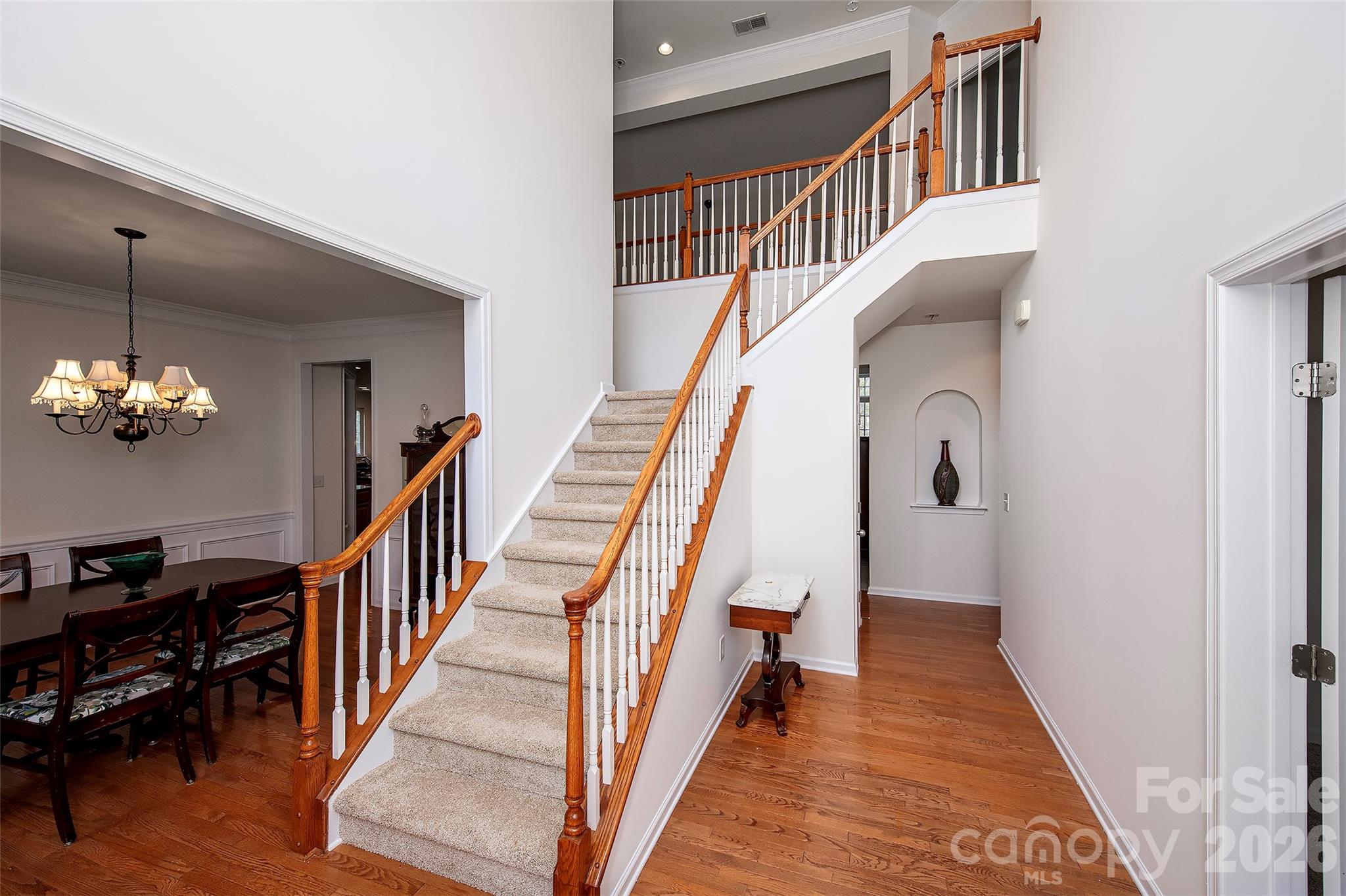1957 Faison Avenue Fort Mill, SC 29708 - Photo 3 of 33 a view of staircase with lots of frames on wall and wooden floor