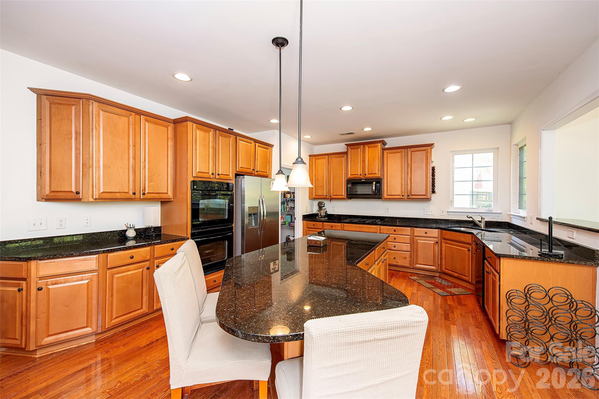 1957 Faison Avenue Fort Mill, SC 29708 - Photo 8 of 33 a kitchen with stainless steel appliances granite countertop a sink a stove and a refrigerator