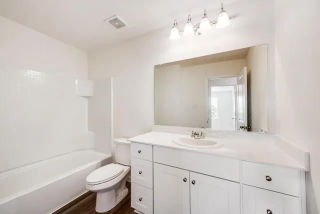 a view of a room with wooden floor and window
