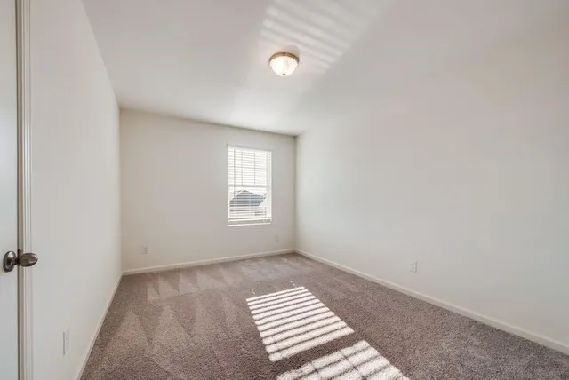 a view of a room with wooden floor and ceiling fan