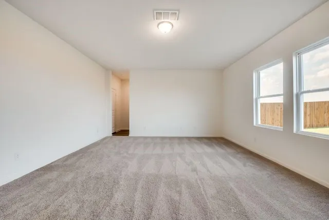 an empty room with a empty space and windows