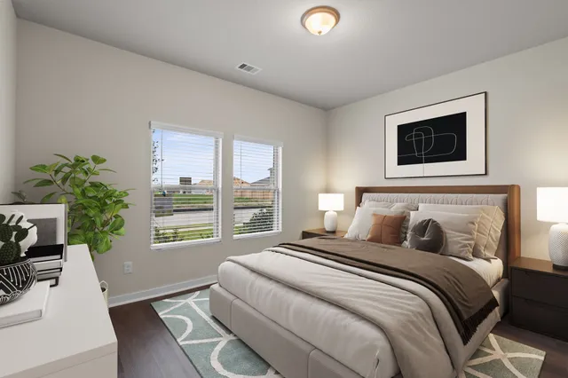 a bedroom with a large bed and a window