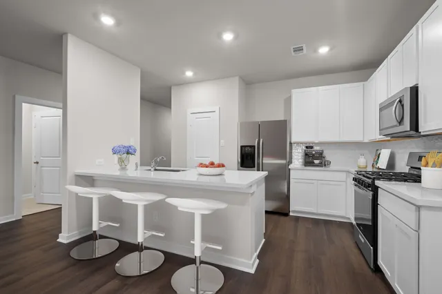 a kitchen that has a sink and a stove in it