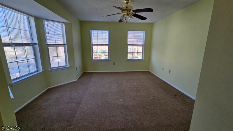 501 Red Crest Lane Somerville, NJ 08876 - Photo 12 of 24 an empty room with windows closet and chandelier fan