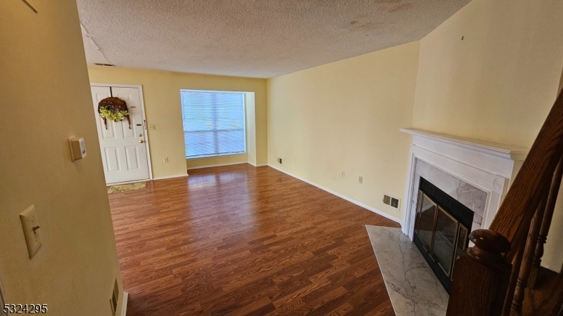 501 Red Crest Lane Somerville, NJ 08876 - Photo 3 of 24 a view of empty room with wooden floor and fireplace