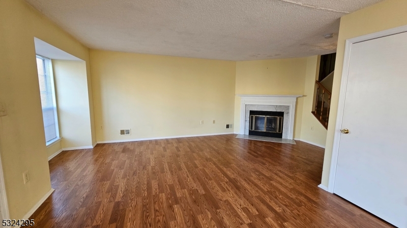 501 Red Crest Lane Somerville, NJ 08876 - Photo 4 of 24 a view of empty room with wooden floor and fireplace