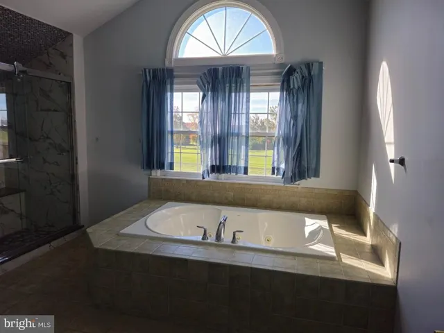 a bathroom with a bathtub and a window