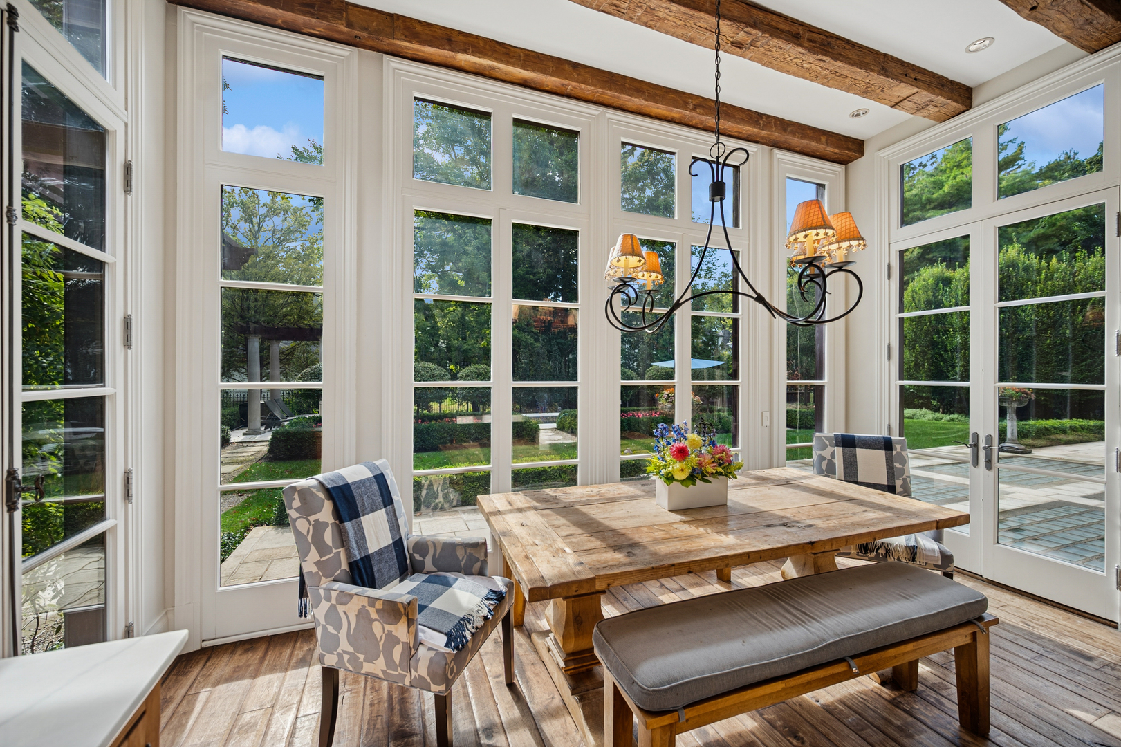 528 Roslyn Road Kenilworth, IL 60043 - Photo 27 of 62 a view of a patio with table and chairs and floor to ceiling window